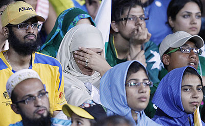 Pakistan fans wear a dejected look after the team's loss to Sri Lanka