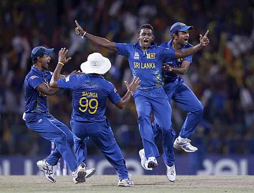 Sri Lanka's Ajantha Mendis celebrates with his teammates after taking the wicket of West Indies Gayle during their Twenty20 World Cup final match in Colombo