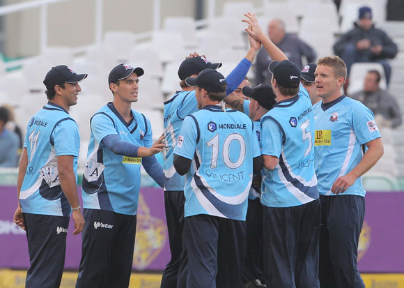 Auckland Aces team-mates celebrate during the CLT20 match against Kolkata Knight Riders
