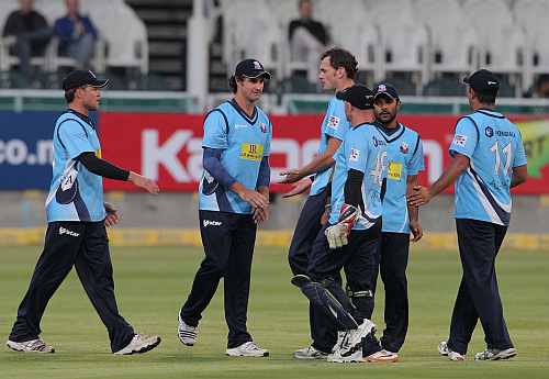 Auckland Aces celebrate after picking up a wicket