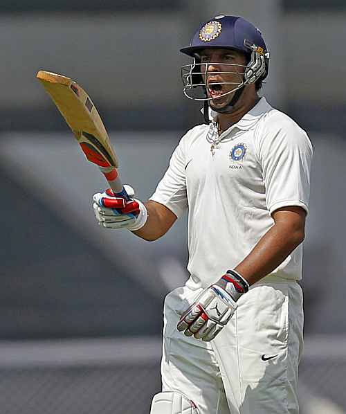 India 'A' team's Yuvraj Singh reacts as he walks back to the pavilion on the first day of the warm-up game against England in Mumbai