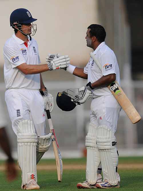 Samit Patel of England (R) and team captain Alastair Cook greet each other at the end of the days play