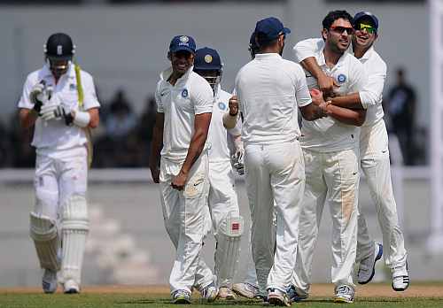 Yuvraj Singh (2nd R) of India 'A' celebrates capturing the wicket of Kevin Pietersen (L) of England with team-mates during the second day of the opening tour match