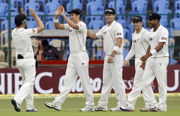 New Zealand's Trent Boult (2nd L) celebrates with teammates after taking a catch off the bowling of teammate Tim Southee to dismiss India's Cheteshwar Pujara