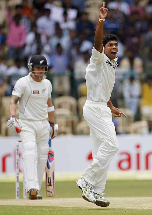 India's Umesh Yadav appeals successfully for wicket of New Zealand's McCullum during third day of their second Test match in Bangalore
