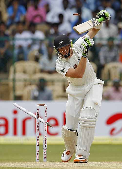 New Zealand's Tim Southee celebrates taking the wicket of India's MS Dhoni during their second Test match in Bangalore