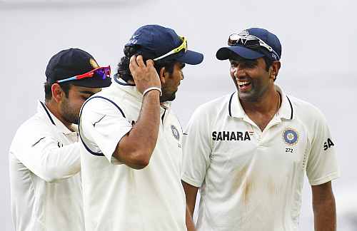 India's R Ashwin smiles as he walks off the field with teammates at the end of the third day's play in their second Test match against New Zealand in Bangalore