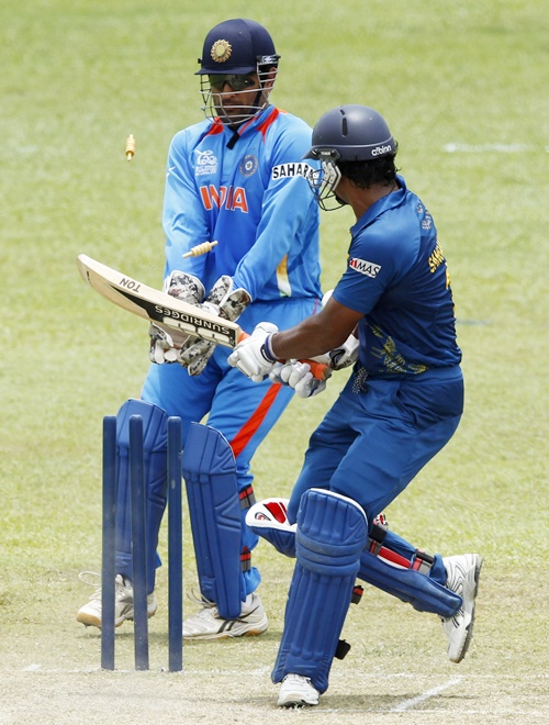 Sri Lanka's Kumar Sangakkara (right) bowled out by India's Harbhajan Singh