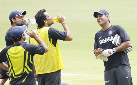 India's captain Mahendra Singh Dhoni (right) while talking to his teammates during a practice session