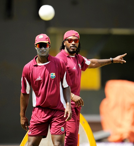 West Indies' captain Darren Sammy (L) and Chris Gayle watch a ball during a training  session