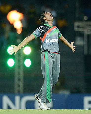 Shapoor Zadran celebrates the wicket of Virender Sehwag