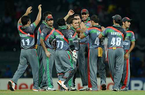 Afghanistan team celebrates after a fall of a wicket