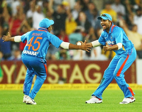 Suresh Raina of India celebrates teammate Rohit Sharma