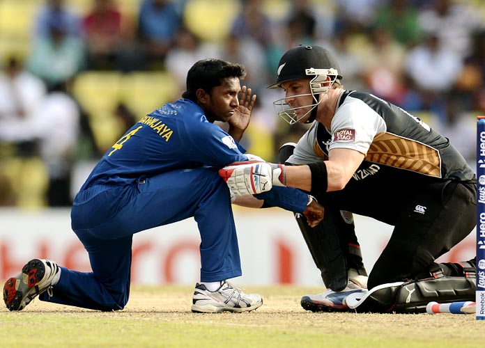 Brendon McCullum (right) speaks to Akila Dananjaya after he was hit on the face