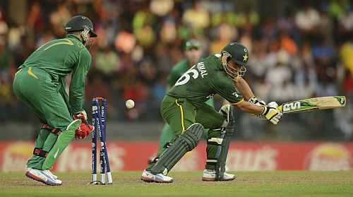 Pakistan's Kamran Akmal is bowled as South Africa's de Villiers looks on during the ICC World Twenty20 Super 8 cricket match at the R. Premadasa Stadium in Colombo