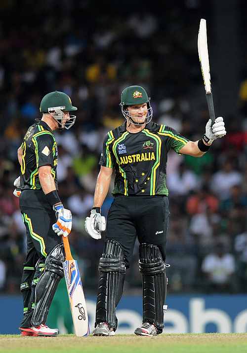 hane Watson of Australia raises his bat after scoring a half century as teammate David Hussey looks on during the Ninth super eight match between Australia and South Africa