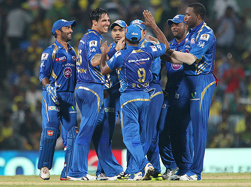 Mitchell Johnson celebrates the wicket of Suresh Raina with his team mates