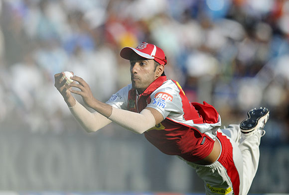 Gurkeerat Mann Singh of Kings XI Punjab dives to take a catch to get Ross Taylor of Pune Warriors out