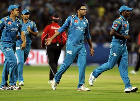 Yuvraj Singh celebrates with teammates after taking a wicket