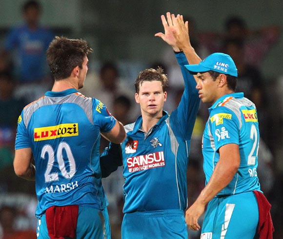 Mitchell Marsh (left) celebrates the wicket of S Badrinath with team mates Steven Smith and Ross Taylor (right)