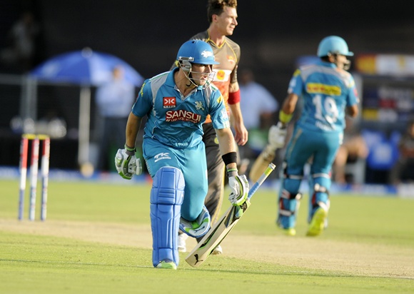 Aaron Finch of Pune Warriors drops his bat as he tries to complete a run