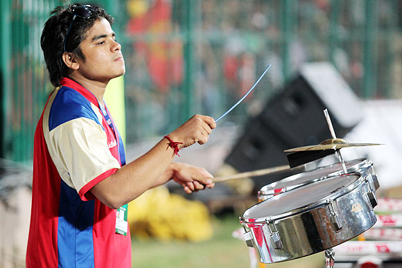 A drummer, supporting RCB, goes on with his job on Tuesday