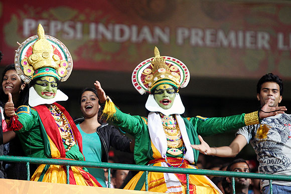 Fans dressed a Indian classical dancers in the stands