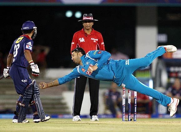 Yuvraj Singh tries to make a diving stop off his own bowling