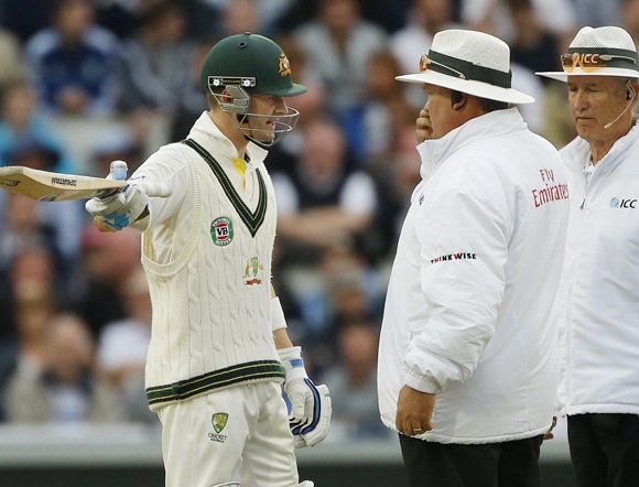Australia's Michael Clarke (left) gestures as he talks with umpires Marais Erasmus (centre) and Tony Hill
