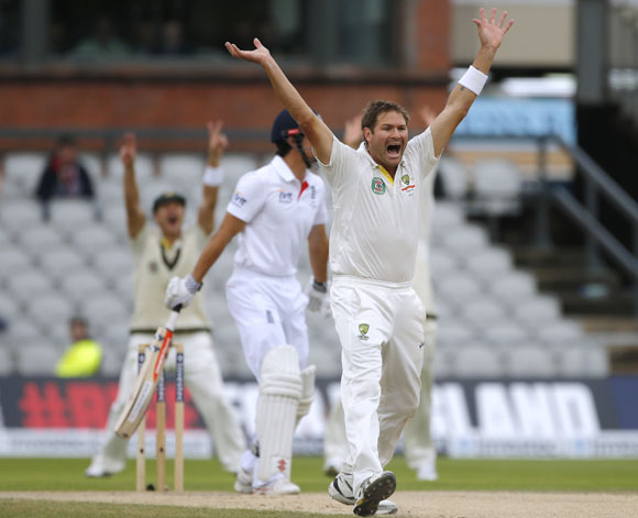 Australia's Ryan Harris (right) successfully appeals for the wicket of England's Alastair Cook (left) on the final day of the third Ashes Test at Old Trafford 