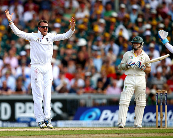 Graeme Swann celebrates after taking the wicket of Chris Rogers
