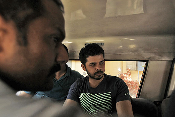 Sreesanth (right) is taken to a court in a police vehicle