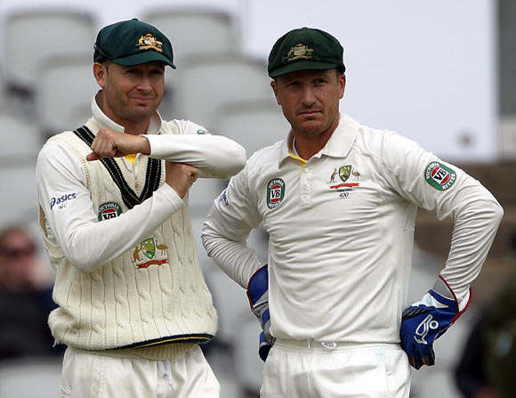 Australia's captain Michael Clarke signals to review the umpires decision as he stands with Brad Haddin
