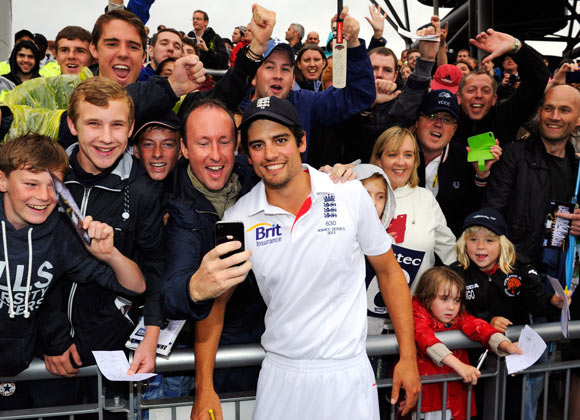 Alastair Cook poses with England fans after winning the third Test in Manchester