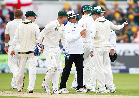 Michael Clarke of Australia speaks to Umpire Aleem Dar after he sucsessfully reviewed a decision against Joe Root of England during Day 1 of 4th Ashes Test on Friday