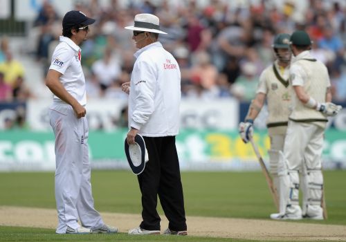 England captain Alastair Cook speaks to umpire Tony Hill after his decision give Chris Rodgers of Australia out is overruled after a referral
