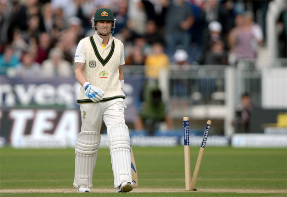 Australia captain Michael Clarke leaves the field after being bowled by Stuart Broad of England