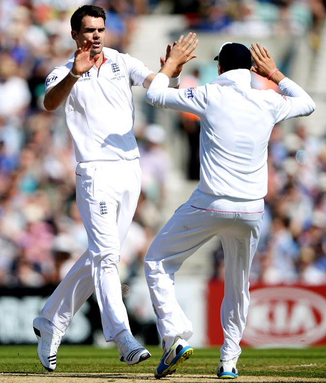 James Anderson (left) celebrates the wicket of David Warner
