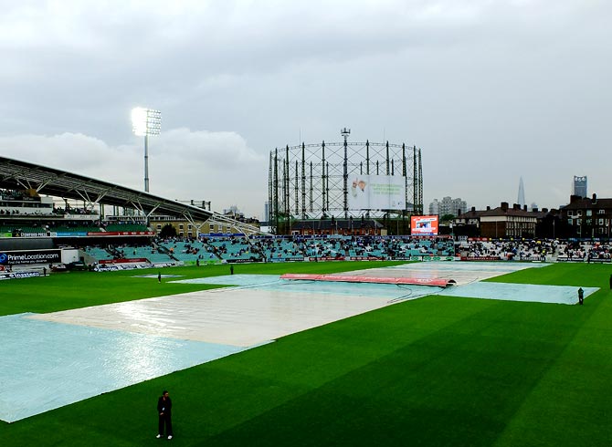 The covers are on as rain delays the start of second day's play.