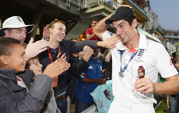 Alastair Cook of England celebrates with fans
