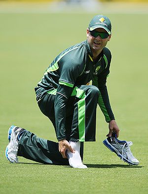 Michael Clarke inspects his ankle during a training session on Monday
