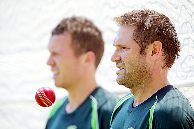 Peter Siddle and Ryan Harris looks on during an Australian nets session at Adelaide Oval in Adelaide on Monday