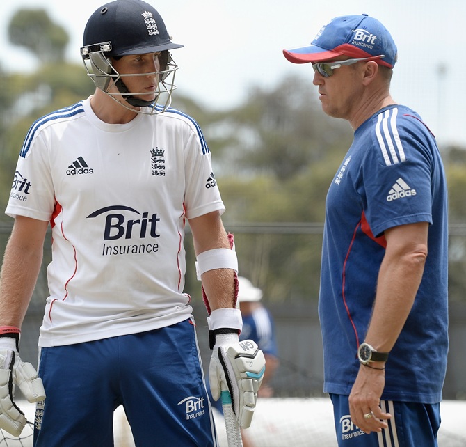 Joe Root of England speaks with coach Andy Flower