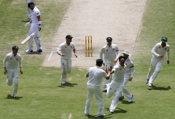Australia's Mitchell Johnson (3rd R) celebrates with teammates after taking the wicket of England's Matt Prior