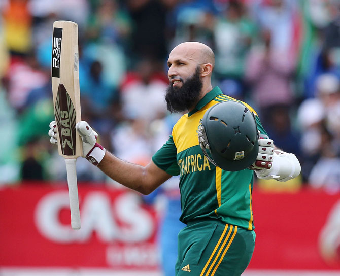 Hashim Amla raises his bat to acknowledge the applause following his hundred. 