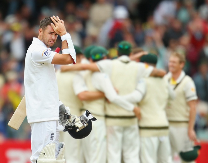 James Anderson of England looks on as Australia celebrate their victory