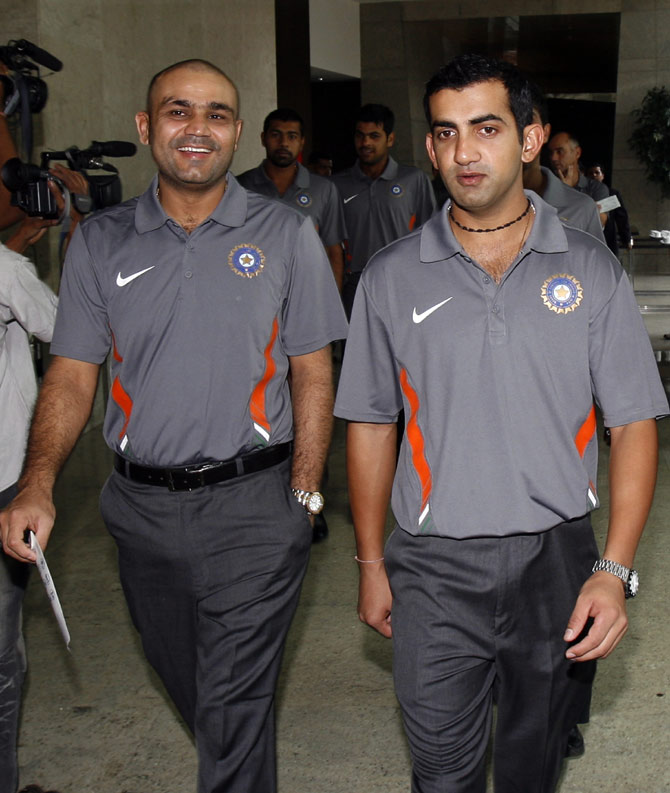 Virender Sehwag (left) and Gautam Gambhir arrive to pose for a team picture