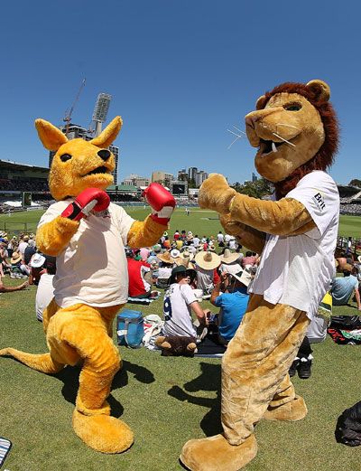 An Australian kangaroo mascot and English Lion mascot pose