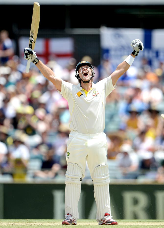 Shane Watson celebrates after completing his century
