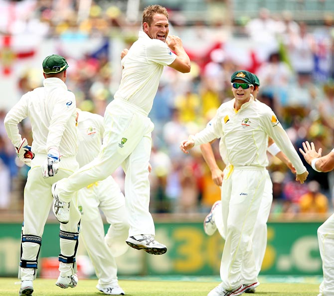 Ryan Harris (centre) celebrates the wicket of Alastair Cook